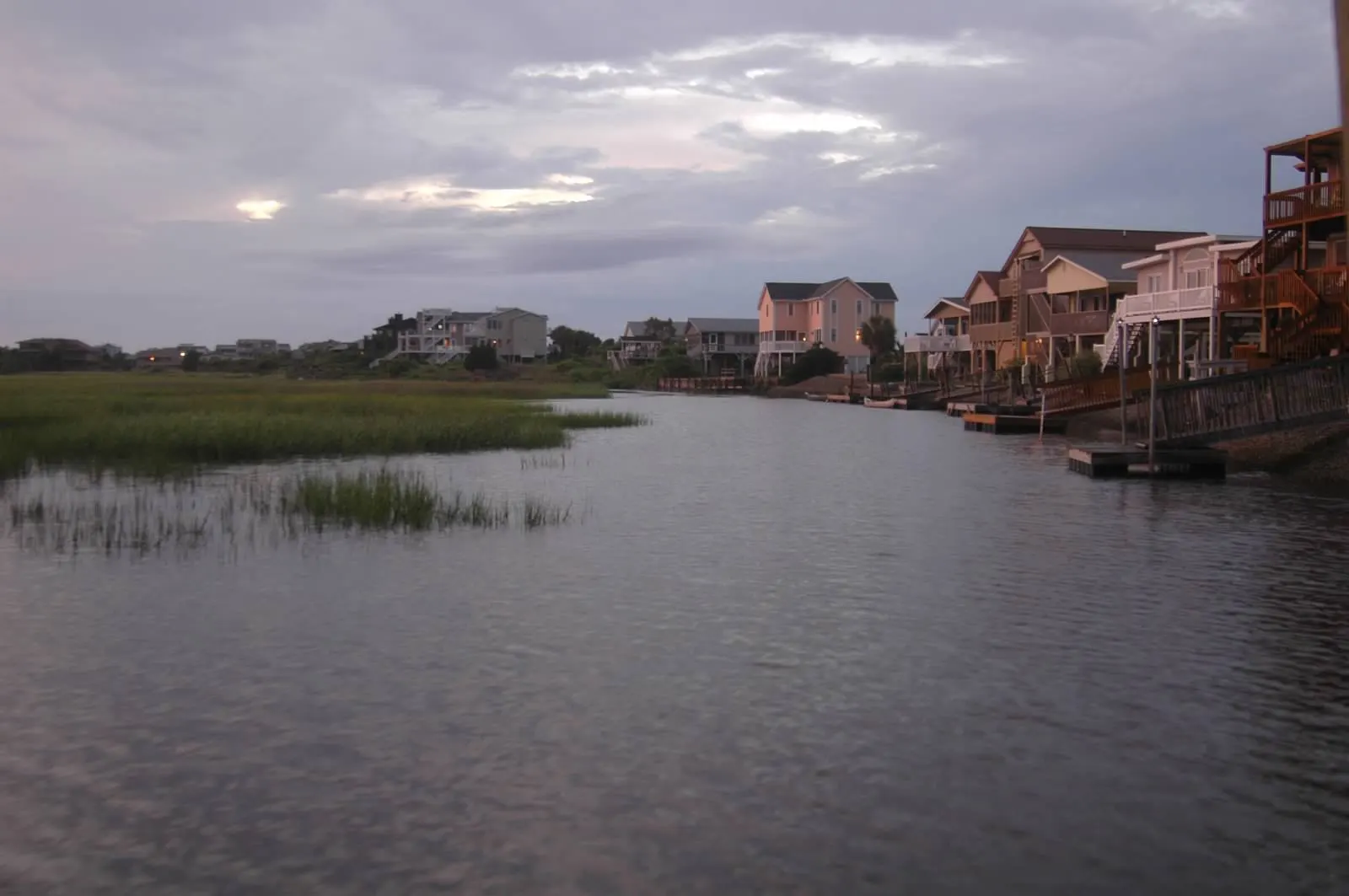 Sunset Beach houses behind the dunes at dusk
